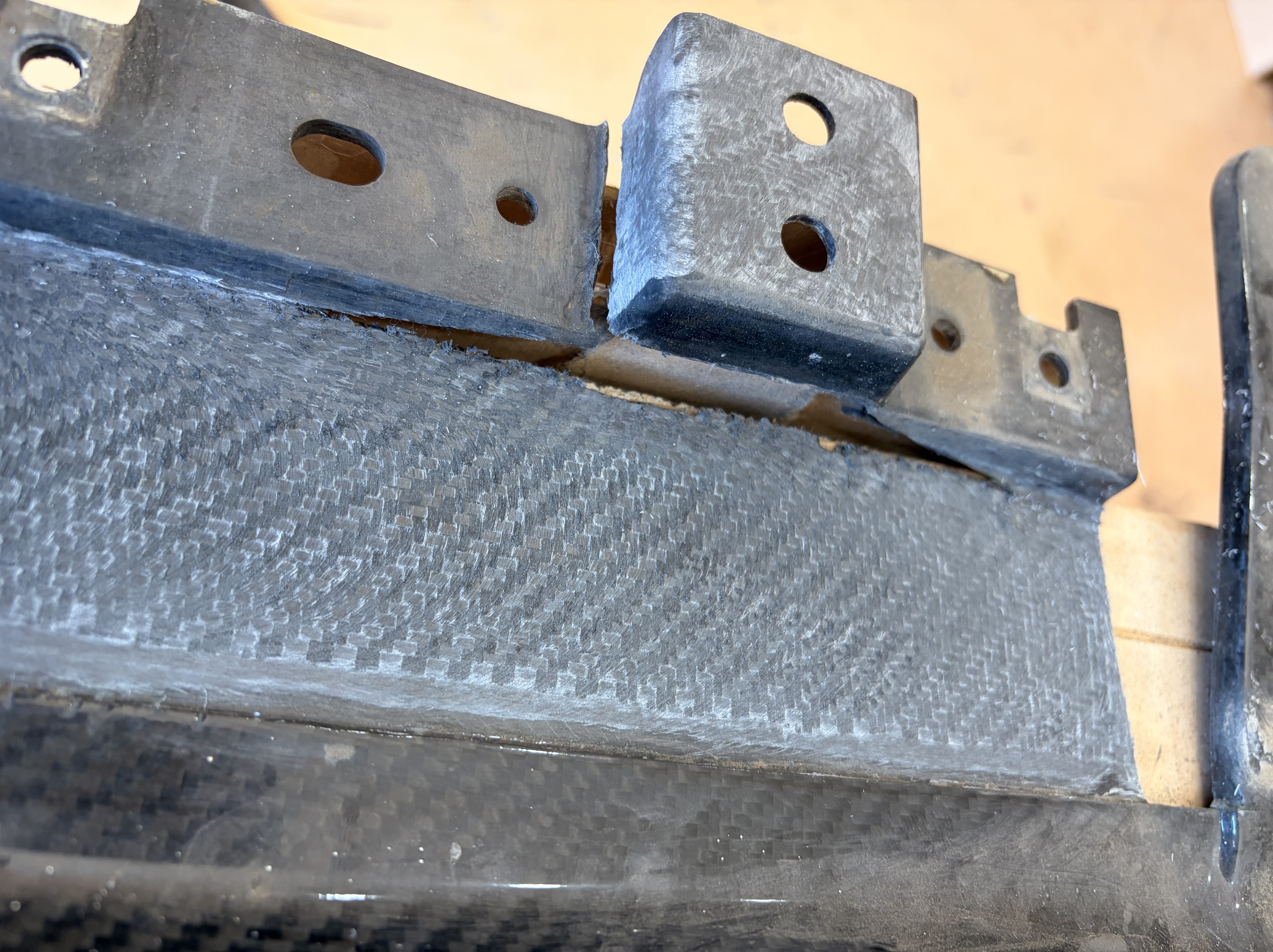 Carbon fibre splitter showing structural crack damage before repair